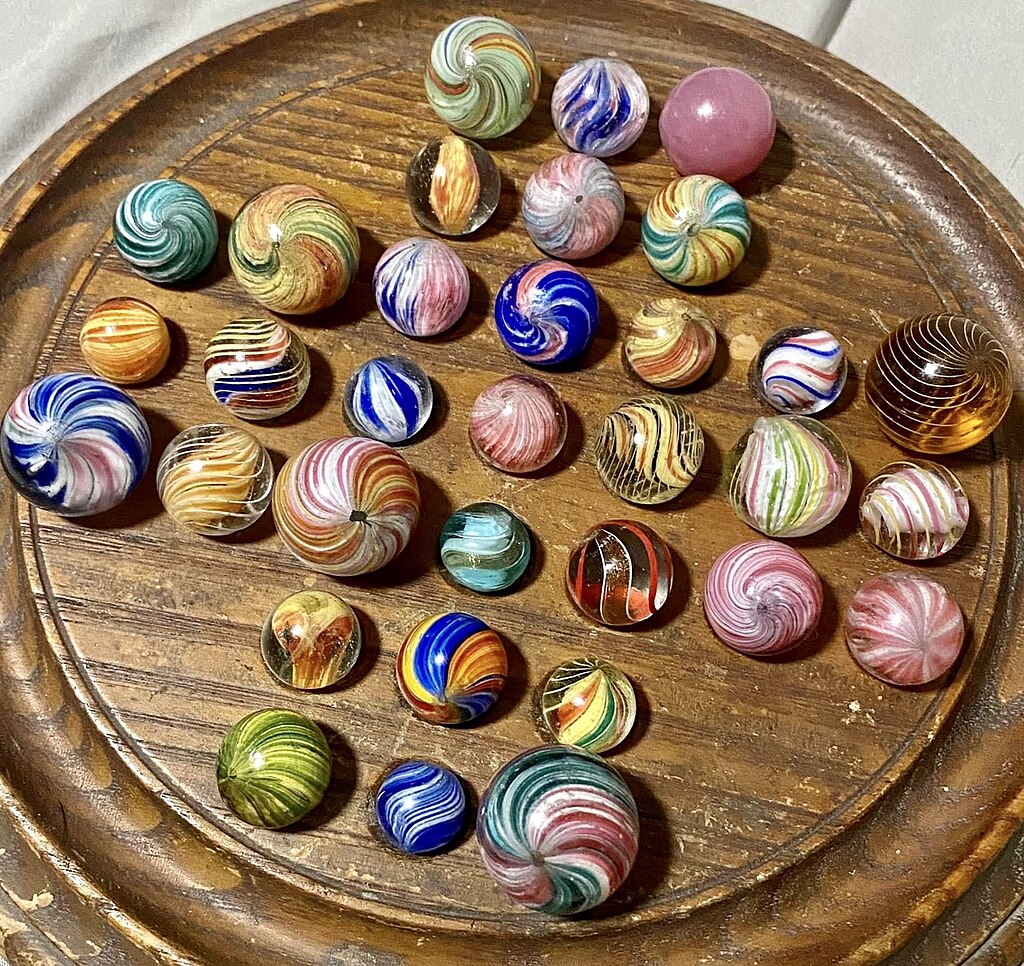 Left) Marbles in an ordered arrangement on a solitaire board ; Right) Silicon atoms ordered within a material Both systems are highly ordered.