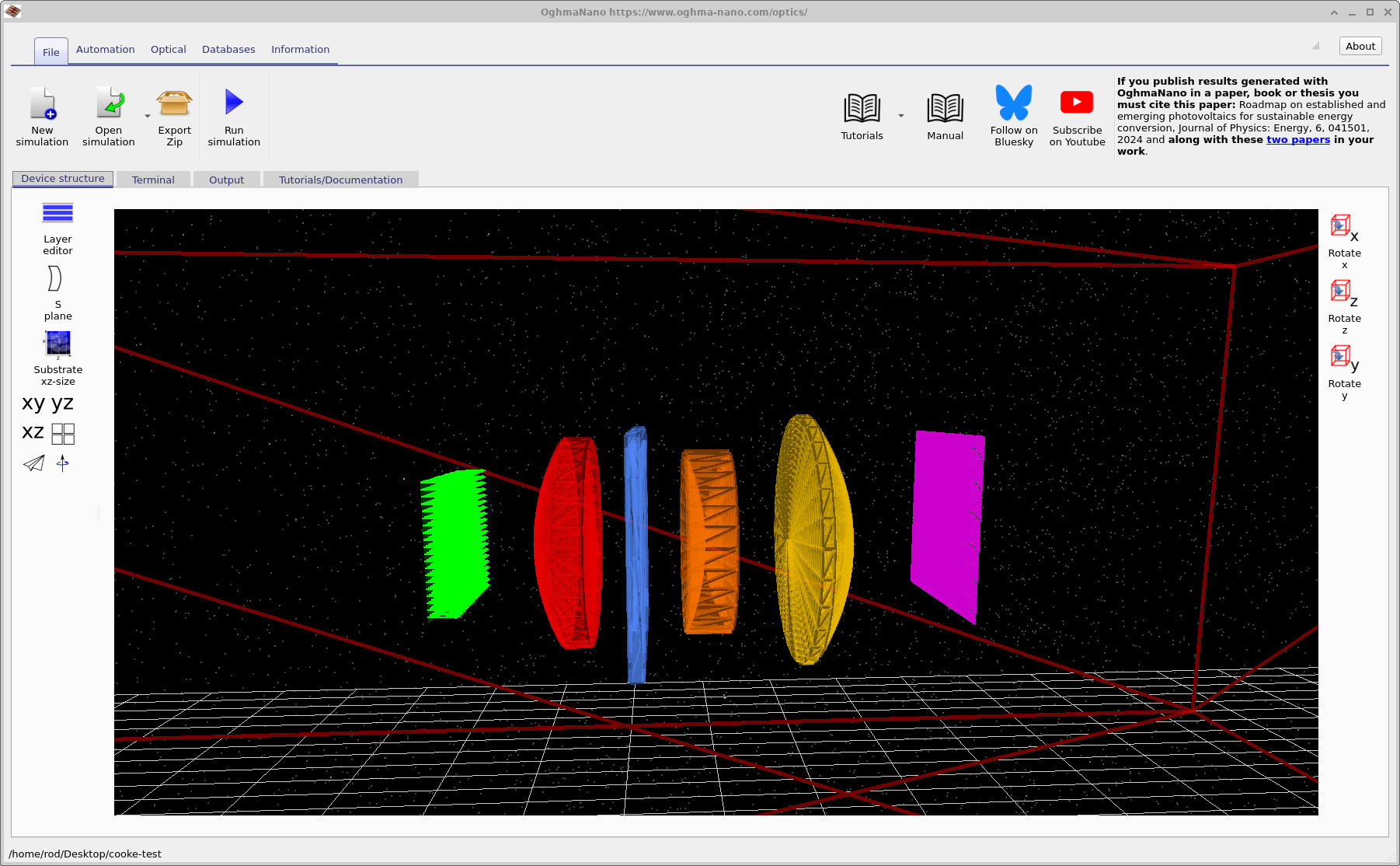 3D ray-tracing view of an example optical system used for figures-of-merit evaluation (source, lenses, stop, detector plane)