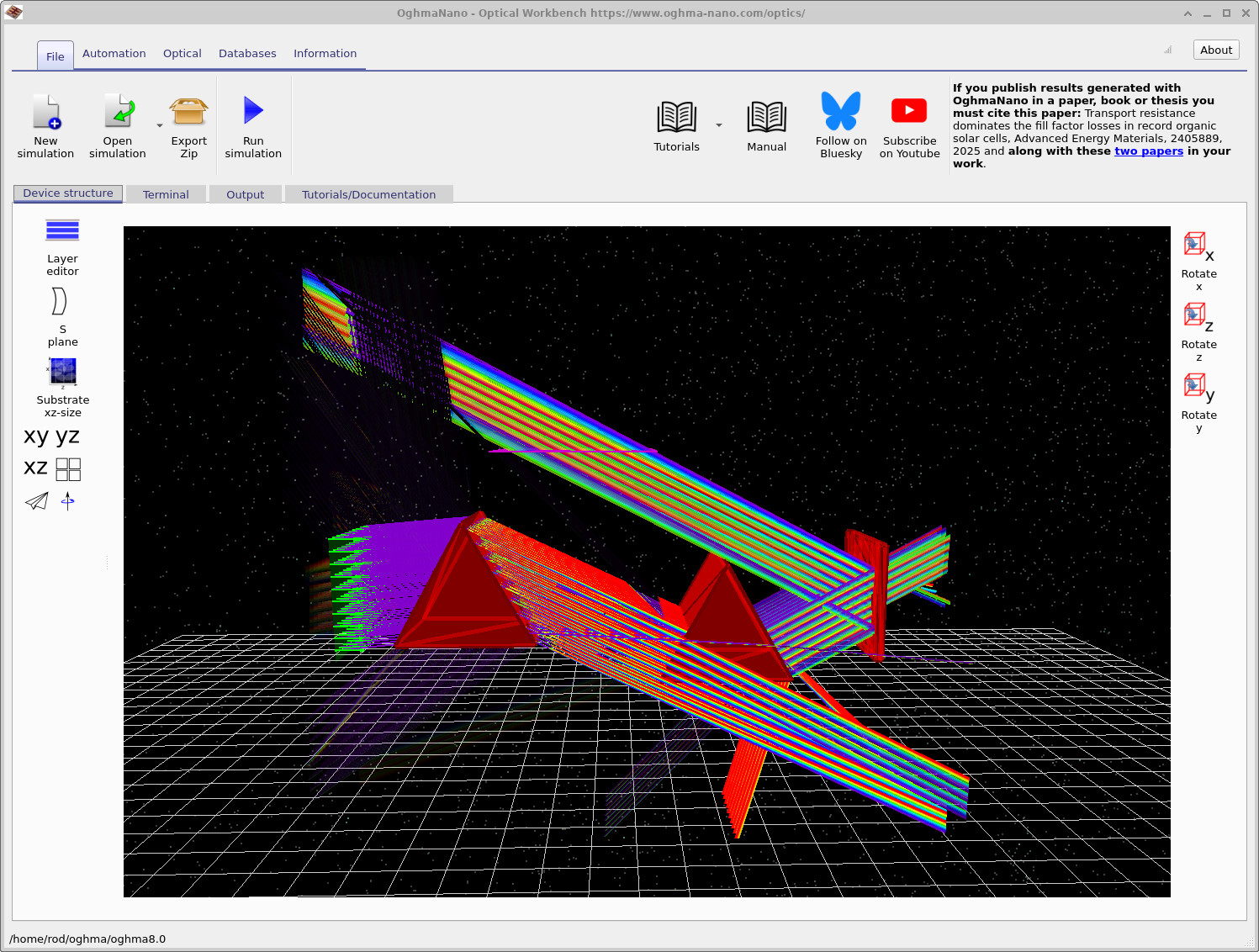 Ray-tracing simulation running, showing coloured rays reflecting and refracting through the prisms and aperture